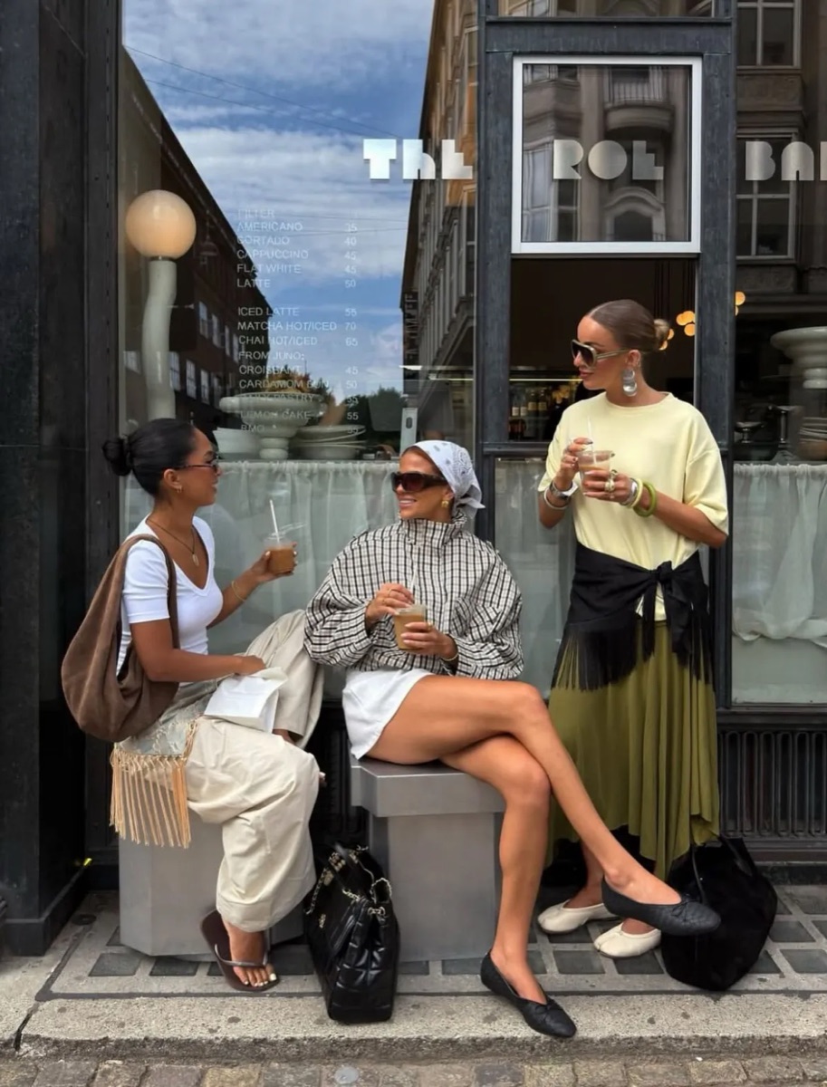 Friends outside a cafe in checks and wide-leg trousers